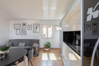 a kitchen and living room with a table and a couch at Barberini Caesar Suites in Rome