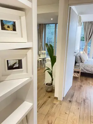 two views of a living room with a fireplace at Green Home in Rome