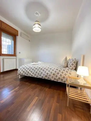 a bedroom with a bed and a table and a chair at Green Home in Rome