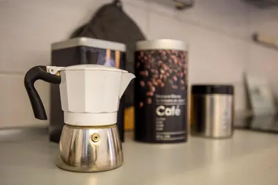 a coffeemaker sitting on a counter next to a coffee pot at Holiday Homes Rome - Portuense 21 - Studio with little private Garden in Rome