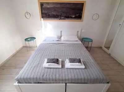 a bed in a room with two chairs and a bedvisor at Il Cortile - Appartamento nel cuore di Testaccio in Rome