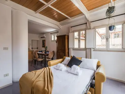 a bedroom with a bed and a dining room at The Best Rent - Two-bedroom apartment with terrace near Trevi Fountain in Rome