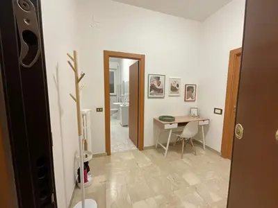 a room with a desk and a table and a bathroom at Casa Sofia Trastevere in Rome