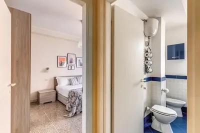 a bathroom with a toilet and a bed in a room at Rdd in Rome