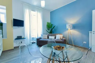 a living room with a couch and a glass table at Etta Suite - Close Vatican Museum in Rome