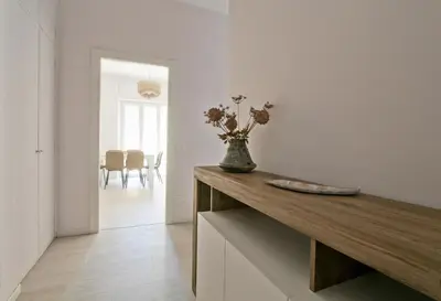 a room with a table with a vase of flowers on it at Martina Garden in Rome