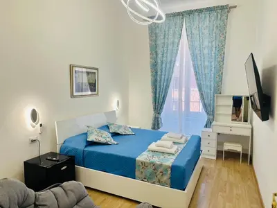 a bedroom with a blue bed and a window at Casa Vacanza Kambal in Rome