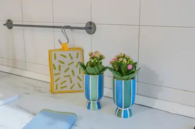 two blue vases with flowers on a counter at Colosseum Flat - ZEN23 in Rome