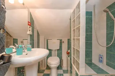 a bathroom with a sink and a toilet and a shower at Dimora Pastini in Rome
