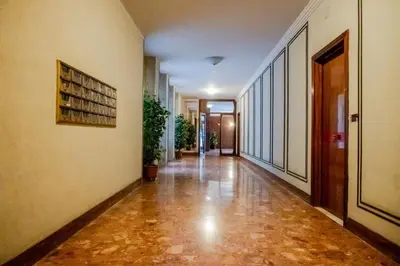an empty hallway of a building with a book shelf at Fleming in Rome