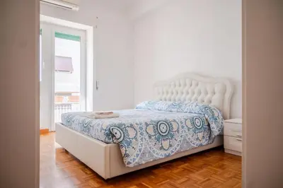 a bedroom with a bed with a blue and white comforter at Fleming in Rome
