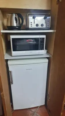a microwave sitting on top of a refrigerator at Sweet Rhome Navona Loft Centro Storico in Rome