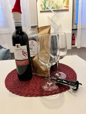a bottle of wine and two glasses on a table at Sweet Rhome Navona Loft Centro Storico in Rome