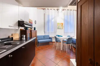 a kitchen and dining room with a table and chairs at Sweet Rhome Navona Loft Centro Storico in Rome
