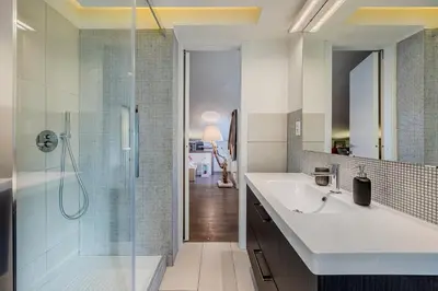 a bathroom with a sink and a glass shower at Casa Doni Roma in Rome