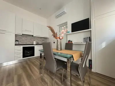 a kitchen with a dining room table and chairs at House of Wonders in Rome
