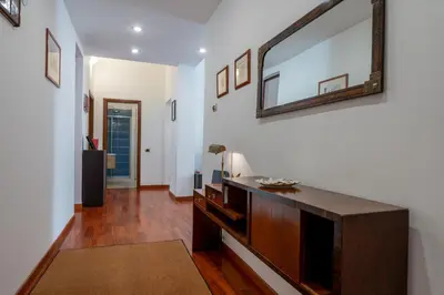 a living room with a large mirror on the wall at Casa Novecento Prati in Rome