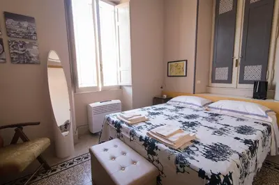 a bedroom with a bed with a blue and white blanket at Il Clivo in Rome