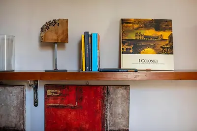 a wooden shelf with books and a picture on it at Il Clivo in Rome