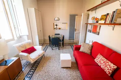 a living room with a red couch and a table at Il Clivo in Rome
