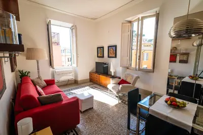 a living room with red couches and a television at Il Clivo in Rome