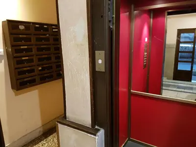 a red door with a mirror in a room at Alenic in Rome