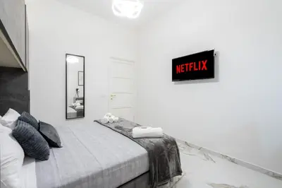 a bedroom with a bed with a sign on the wall at Picorini House in Rome