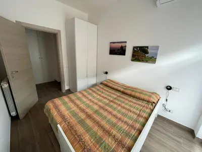 a bedroom with a bed with a blanket on it at Comfort a 7 fermate dal Colosseo in Rome