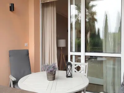 a white table and chairs in a room with a window at Vatican City Green Apartment in Rome