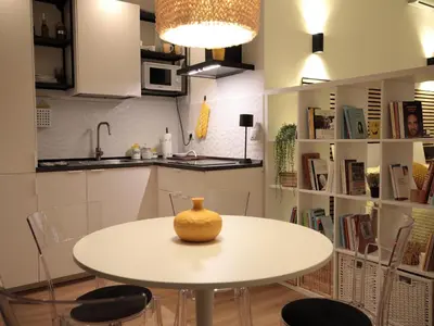 a table in a kitchen with a vase on it at Vatican City Green Apartment in Rome
