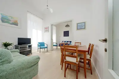 a living room with a couch and a table and chairs at FM Apartment in Rome