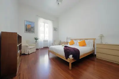 a bedroom with a bed and a dresser in it at FM Apartment in Rome