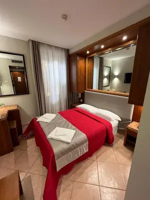 a bed with two pillows on top of it at Affittacamere REGIO in Rome