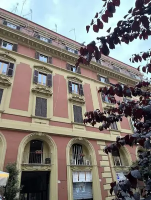 a pink building with arches and windows on it at portapia in Rome