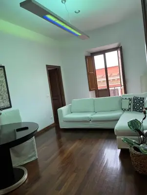 a living room with a white couch and a table at portapia in Rome