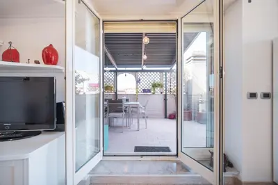 a glass door leading to a patio with a dining room at Tiber House 60 Rome Marconi - Rome Vacation M&D in Rome