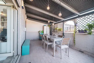 a patio with a table and chairs on it at Tiber House 60 Rome Marconi - Rome Vacation M&D in Rome