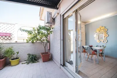 a patio with a table and a glass door at Tiber House 60 Rome Marconi - Rome Vacation M&D in Rome