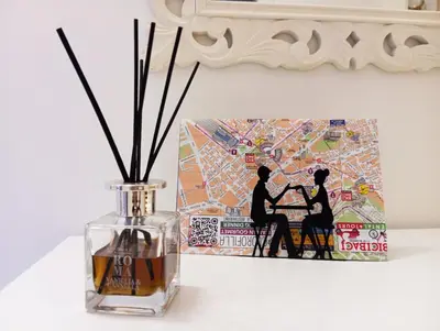 a vase with sticks in it next to a picture at Alessandro Luxury Home Rome in Rome