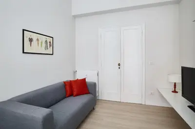 a living room with a couch and a television at Domus Modista (Musei Vaticani) in Rome