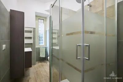 a glass shower in a bathroom with a sink at Domus Alberico 11 (Vaticano) in Rome