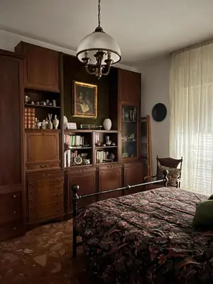 a bedroom with a bed and a chandelier at Semini di nostalgia in Rome