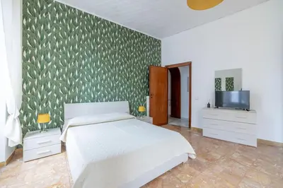 a bedroom with a bed and a flat screen tv at San Lorenzo Residence two in Rome