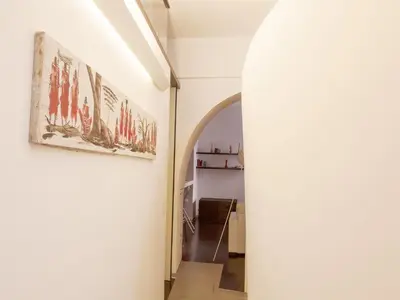 a hallway with an archway and a white wall at Trastevere Art House in Rome