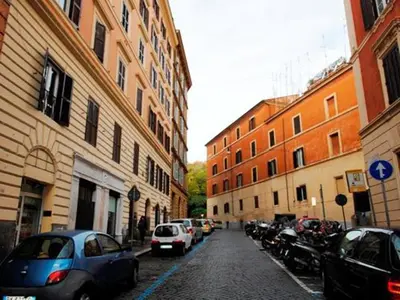 a city street with cars parked on the street at Trastevere Art House in Rome