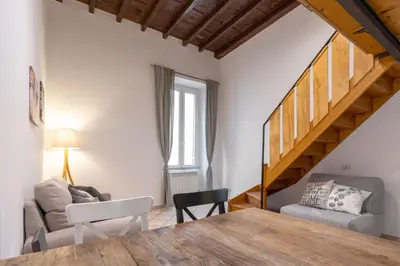 a living room with a table and a couch at vatican apartment gianicolo in Rome