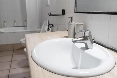 a bathroom with a white sink and a toilet at vatican apartment gianicolo in Rome