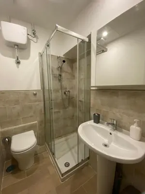a bathroom with a shower and a toilet and a sink at Eureka Rooms in Rome
