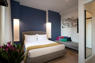 a hotel room with a bed and a couch at ElevenG in Rome