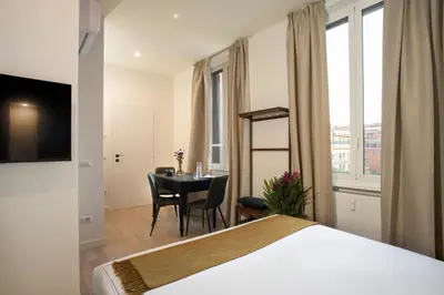 a hotel room with a bed and a table with chairs at ElevenG in Rome